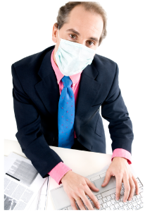 man with health mask on sitting at desk